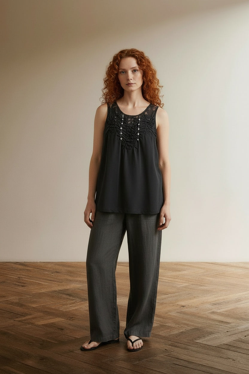 Full body view of the model wearing Marc Cain Top Zwart Kant Maat N4 (L-XL) – Mouwloze Designer Top met Luxe Details