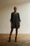 Full body view of the model wearing OPUS Jurk maat 36 zwart