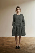 Full body view of the model wearing Essentiel Antwerp Zijden Jurk Maat 36 – Zwart-Witte Printjurk met Kantdetail en Lange Mouwen
